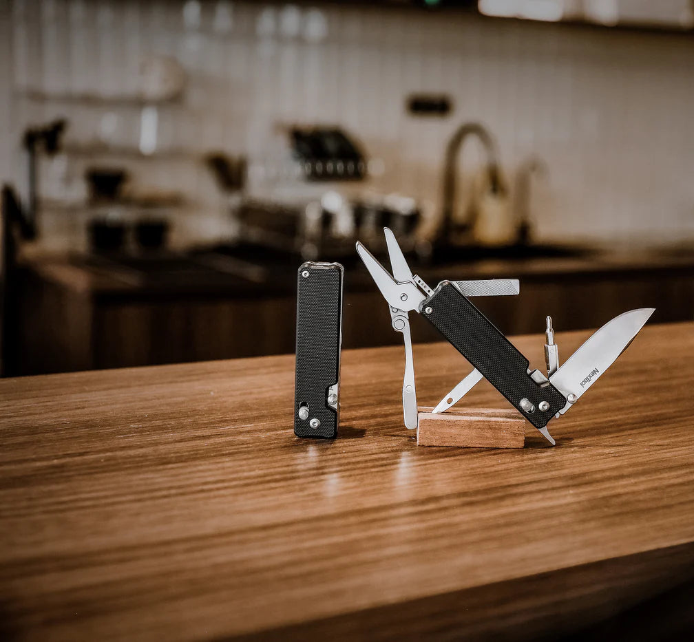 Multitool on a wooden stand with a kitchen in the background